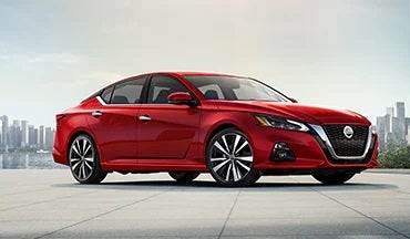 2023 Nissan Altima in red with city in background illustrating last year's 2022 model in Don Moore Nissan in Owensboro KY